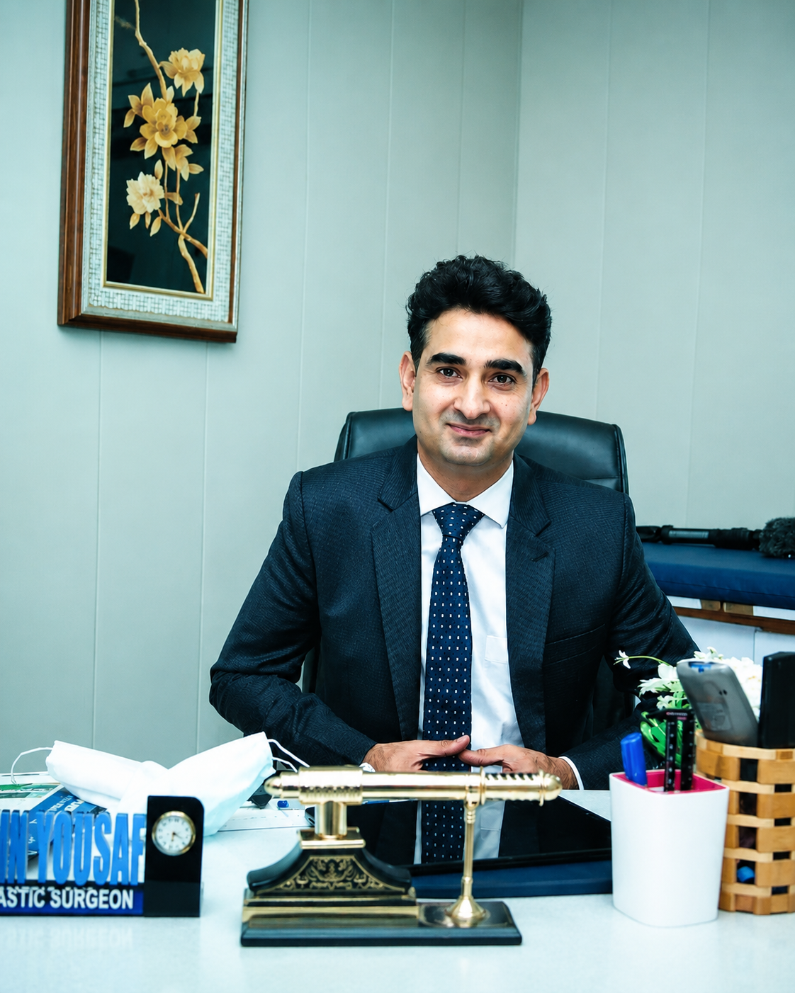 Dr. Amin Yousaf, Consultant Plastic and Reconstructive Surgeon, in his clinic